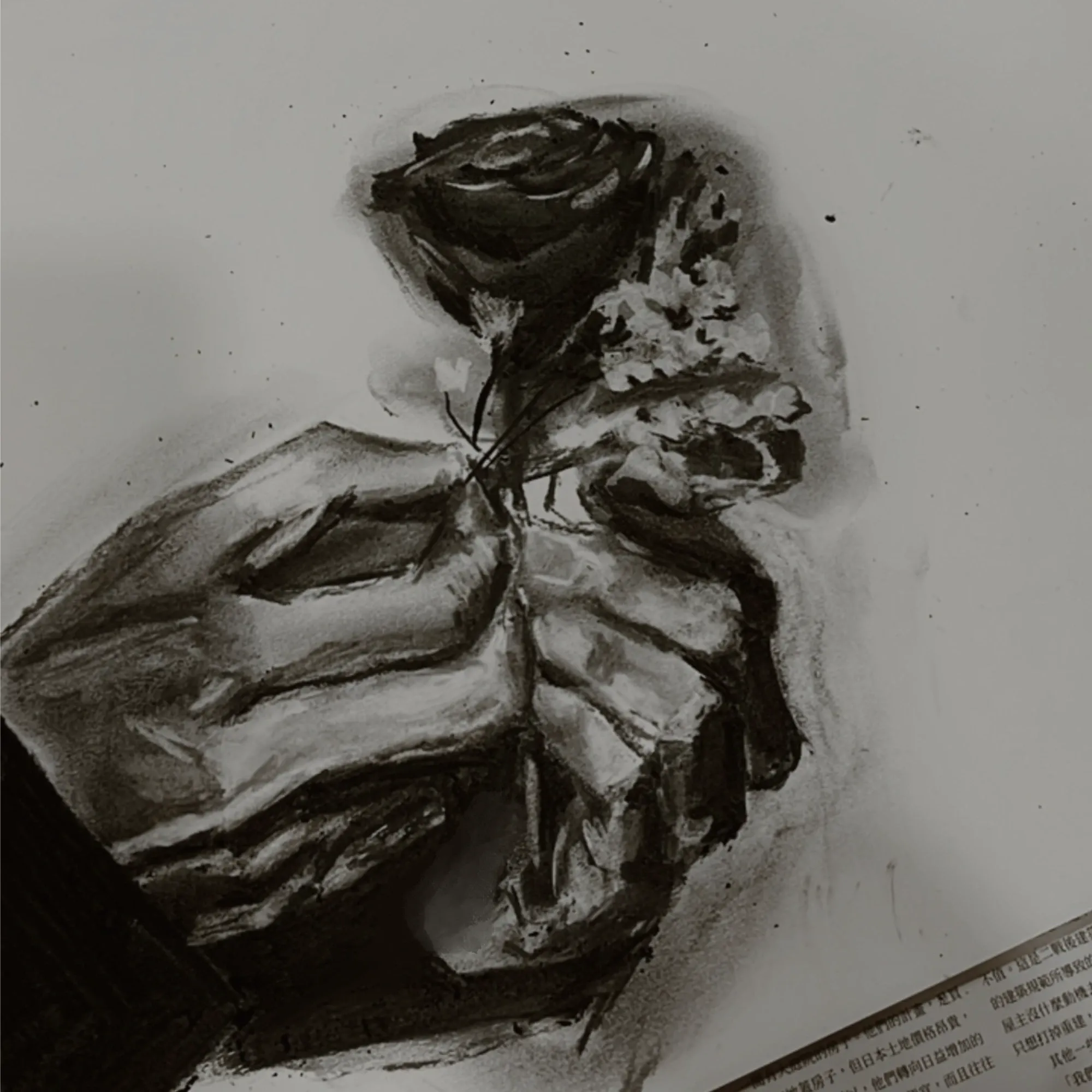A charcoal drawing of a hand holding a rose and baby’s breath